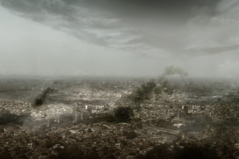 Dramatic view of cityscape with dark cloudscapes